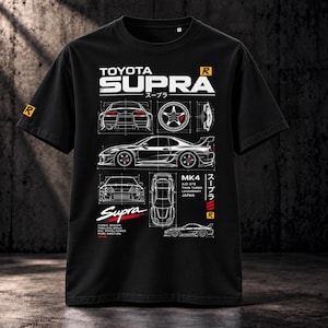 May include: A black short-sleeve t-shirt featuring a white graphic print of a Toyota Supra MK4. The design includes technical line drawings of the car from multiple angles, wheel details, and text including Toyota Supra, MK4, 2JZ-GTE, and Twin Turbo.