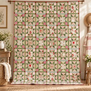 May include: A large rectangular quilt featuring a repeating star pattern in shades of green, pink, and cream. The fabric displays various holiday-themed illustrations including nutcrackers, snowmen, and floral motifs, finished with a red border.