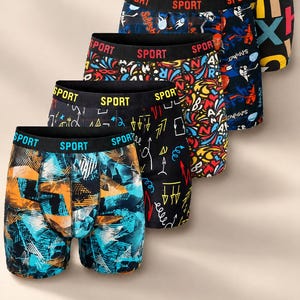 May include: A set of five boxer briefs featuring black elastic waistbands with the word SPORT printed in repeating patterns. Each pair displays distinct colorful graphic prints including abstract shapes, arrows, letters, and sports-themed motifs.