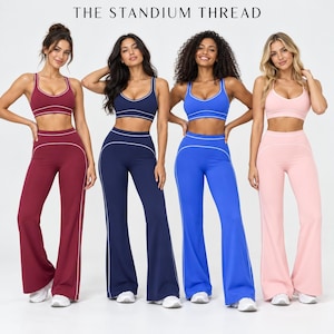 May include: Four matching sets of athletic wear, each consisting of a sports bra and high-waisted flared leggings with white piping accents. The sets are in burgundy, navy blue, royal blue, and light pink. Text reads THE STANDIUM THREAD.
