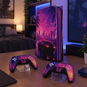 May include: A gaming console and two wireless controllers featuring a vibrant purple and orange sunset cityscape graphic with palm trees, a sports car, and the stylised text VI. The console stands vertically, while the controllers rest on stands.