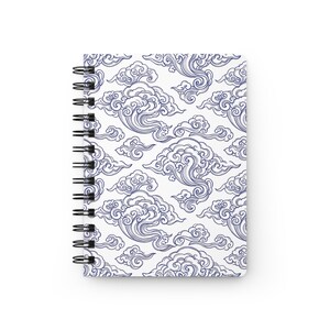 May include: A spiral-bound notebook featuring a repeating pattern of dark blue stylized clouds on a white background. The cover displays intricate, swirling line work that creates a dense, decorative motif across the entire front surface.