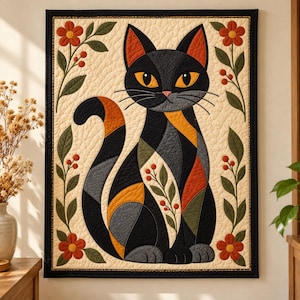 May include: A rectangular wall quilt featuring a stylized black cat with orange and gray geometric patches. The cat is centered on a cream background, framed by vertical vines with green leaves and orange flowers on both sides.