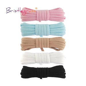 May include: Five bundles of flat elastic cord arranged vertically, each featuring a different solid color: light pink, light blue, beige, white, and black. The brand name Bristlegrass is printed in the upper left corner of the image.