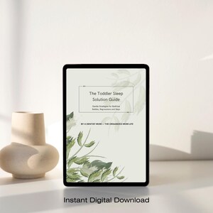 May include: A tablet screen displaying a digital document titled The Toddler Sleep Solution Guide, featuring the subtitle Gentle Strategies for Bedtime Battles, Regressions and Naps by A Dentist Mom – The Organized Mom Life, with green leaf art.