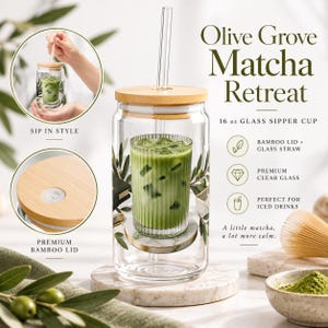 May include: A 473 ml clear glass sipper cup featuring an olive branch design, a bamboo lid, and a glass straw. The cup is labelled Olive Grove Matcha Retreat and includes a bamboo lid with a silicone seal and a clear glass straw for iced drinks.