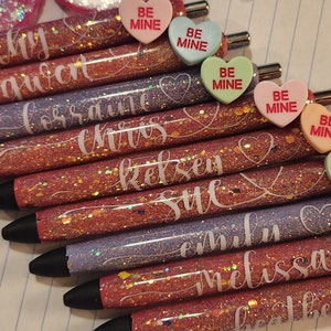 May include: A set of ten glitter pens with personalized names and heart-shaped candy charms that say "Be Mine".