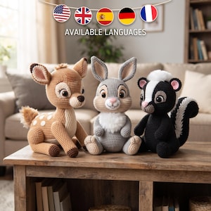 May include: Three crocheted stuffed animals sitting on a wooden surface. A tan deer with white spots, a grey rabbit with a white chest, and a black and white skunk with a fluffy tail. Each animal features large dark eyes and stitched details.