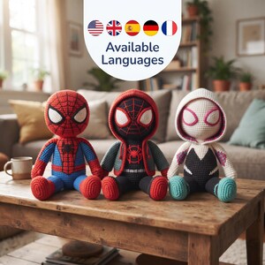 May include: Three handmade crochet dolls featuring superhero designs. The left doll is red and blue with a spider emblem. The center doll is black and red with a hooded jacket. The right doll is white, black, and teal with a hooded design.