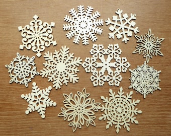 Set of eleven 3 1/8 to 4 1/4 inch laser cut wood snowflakes in various patterns, great for holiday crafting or decor.