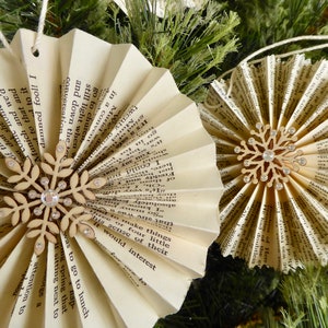 Nine handmade vintage book paper ornaments with wood snowflakes and crystals, between 3.5 and 4 inches across
