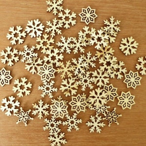 45 small quarter-sized laser cut wood snowflakes for crafting, about 7/8 inches across