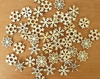 45 small quarter-sized laser cut wood snowflakes for crafting, about 7/8 inches across