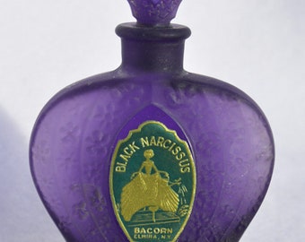 Exquisite original antique BLACK NARCISSUS perfume bottle in a Pretty Purple COLOR, embossed, labeled, w/ glass stopper.