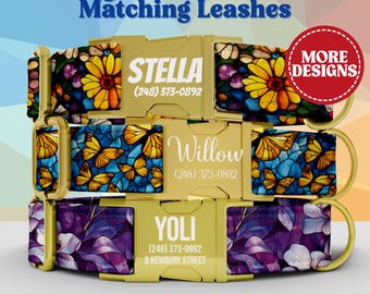 May include: Three dog collars with gold-tone metal buckles, each featuring a unique pattern: yellow sunflowers, orange butterflies, and purple floral designs. Each buckle is engraved with a name and phone number, including Stella, Willow, and Yoli.