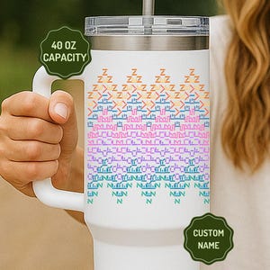 May include: White 40 oz tumbler with a handle, featuring a colorful pattern of Z's and other shapes. The tumbler has a clear lid and a straw. The capacity is labeled as 40 oz.