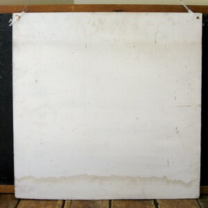May include: A weathered, off-white square sign with a wooden frame and a wire for hanging. The sign has visible stains and imperfections, suggesting age and use. The bottom edge shows a water stain.