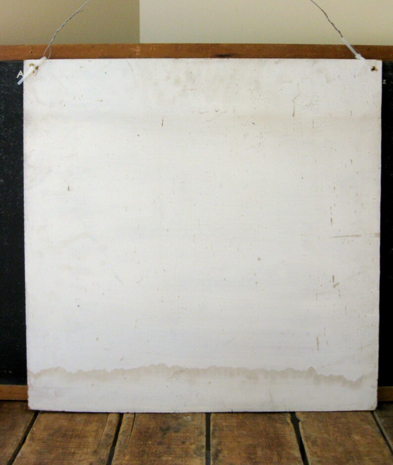 May include: A weathered, off-white square sign with a wooden frame and a wire for hanging. The sign has visible stains and imperfections, suggesting age and use. The bottom edge shows a water stain.