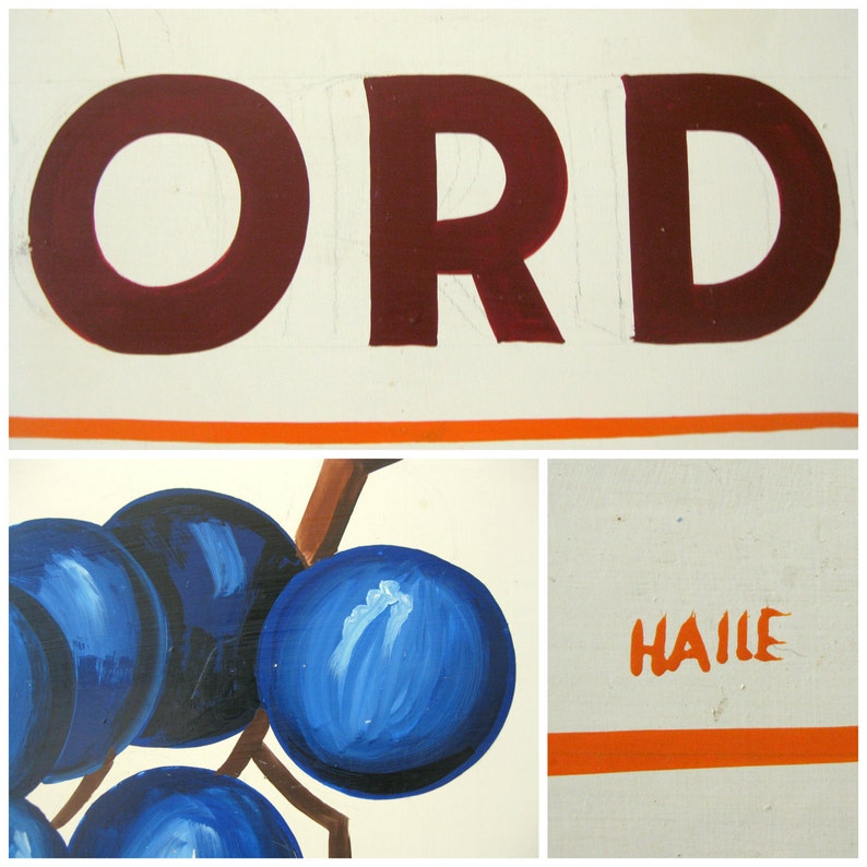 May include: A painted sign with the word "ORD" in dark red letters above an orange stripe. Below, a cluster of blue grapes with brown stems. The word "HAILLE" is written in orange.