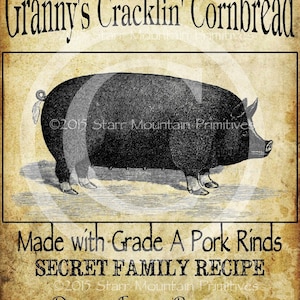 May include: Vintage style illustration of a pig with the text "Granny's Cracklin' Cornbread" at the top and "Made with Grade A Pork Rinds SECRET FAMILY RECIPE" in the middle. The text at the bottom reads "DUGGAN FAMILY PRODUCTS Coker Creek, TN".