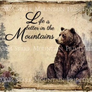 May include: A vintage-style print with a brown bear sitting in a forest setting. The print features the text "Life is better in the Mountains" with a rustic background.