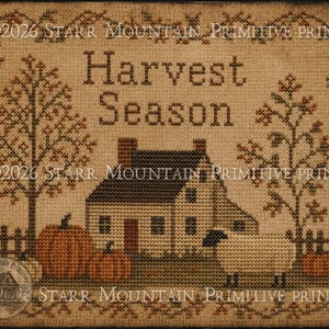 May include: A cross-stitch pattern on tan fabric featuring the text Harvest Season, a house, two trees, pumpkins, and a sheep. The design includes a decorative border and the copyright text 2026 STARR MOUNTAIN PRIMITIVE PRINTS repeated throughout.