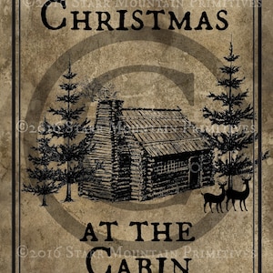 May include: A vintage-style Christmas illustration featuring a rustic cabin in the woods with two deer standing in front of it. The text "Christmas at the Cabin" is printed in black on a brown background.