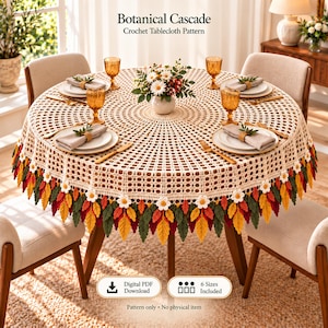May include: A round cream-colored crochet tablecloth featuring a repeating grid pattern and a decorative border of crocheted white flowers and multi-colored leaves in shades of green, yellow, and red. Text reads Botanical Cascade.