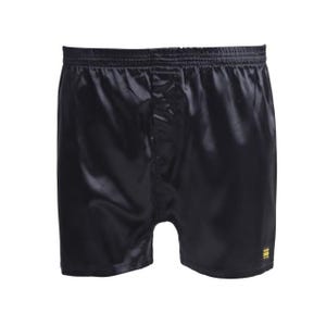 May include: A pair of black satin boxer shorts featuring an elasticated waistband and a small rectangular yellow label with black text positioned on the lower right leg. The fabric has a smooth, reflective finish with a visible central seam.