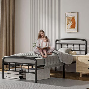 May include: A black metal bed frame with a rounded headboard and footboard, featuring a gray quilted mattress cover. The frame has a sturdy tubular design with decorative spherical accents on the vertical posts, providing a classic look.