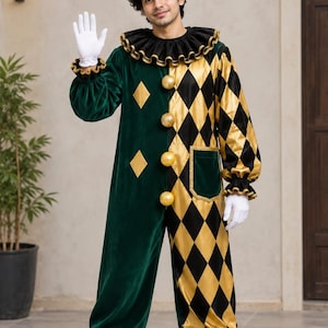 Könnte beinhalten: Ein Clownskostüm mit einer Seite aus grünem Samt und einer Seite mit schwarz-goldenem Rautenmuster. Der Overall umfasst einen schwarzen Rüschenkragen, goldene kugelförmige Knöpfe, einen passenden spitzen Hut mit goldenen Bommeln und weiße Handschuhe.