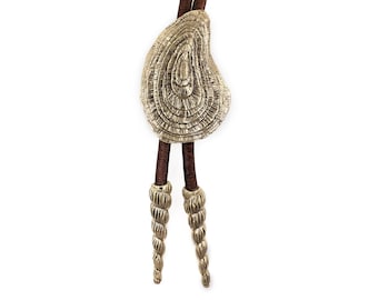 Oyster bolo tie with spire shell endcaps, in solid sterling silver or brass, strung with genuine Greek leather cord.