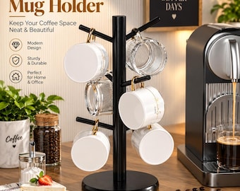 May include: A black vertical mug holder with multiple branches for hanging cups. The stand features a central pole and a circular base. Several white and clear glass mugs with gold-toned handles are suspended from the arms of the holder.
