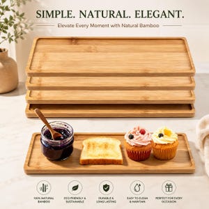 May include: A stack of four rectangular bamboo serving trays with a light wood grain finish. Below, a single tray holds a glass jar of dark jam with a wooden spoon, a slice of toasted bread, and two cupcakes with frosting. Text reads: SIMPLE. NATURAL. ELEGANT.