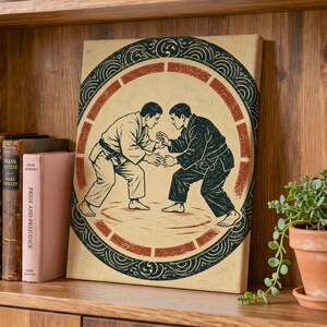 May include: A rectangular canvas print featuring a black and white illustration of two judo practitioners in a grappling stance. The figures are enclosed within a circular frame with decorative black scrollwork and a segmented red border on a tan background.
