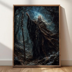 May include: A framed wall art print depicting an elderly figure with long white hair wearing a dark brown hooded cloak. The figure stands in a dark, misty forest, reaching one hand toward a bright light above while holding a tall wooden staff.