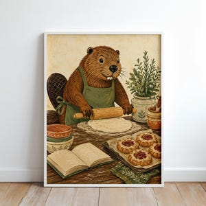 May include: A framed wall art print featuring a brown beaver wearing a green apron, using a wooden rolling pin to flatten dough on a wooden table. The scene includes a stack of bowls, an open cookbook, a potted herb plant, and a tray of baked tarts.