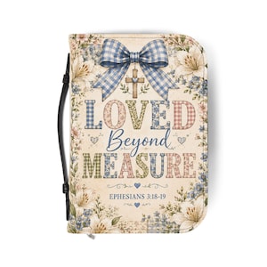 May include: A rectangular book cover featuring a blue and white gingham bow above a cross. The text reads LOVED BEYOND MEASURE and EPHESIANS 3:18-19. The design includes floral patterns in soft tones of cream, blue, and pink with a black handle.