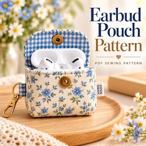 May include: A fabric earbud pouch with a blue floral print on a cream background, featuring a blue gingham interior, a gold metal snap closure, and a gold swivel clasp. The text reads Earbud Pouch Pattern and PDF SEWING PATTERN.