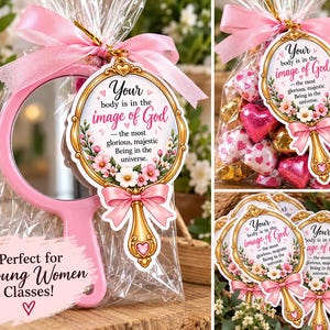 May include: A pink hand mirror packaged in a clear plastic bag with a pink ribbon and a decorative tag. The tag features a gold frame, floral accents, and the text: Your body is in the image of God—the most glorious, majestic Being in the universe.
