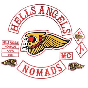 May include: A set of embroidered patches featuring the text HELLS ANGELS in a red arch, a central winged skull emblem in yellow, red, and white, a NOMADS rocker patch, an MC patch, two smaller winged skull patches, and two diamond-shaped 1% patches.