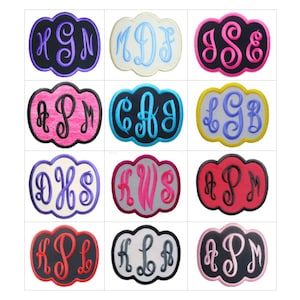 May include: A collection of twelve cloud-shaped embroidered patches, each featuring a unique three-letter monogram in various color combinations including black, white, pink, blue, red, and gray with contrasting thread and border stitching.