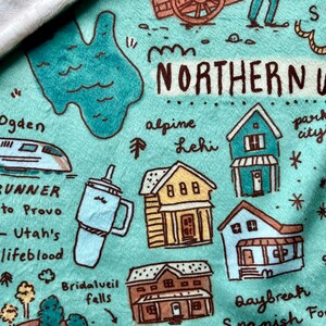 May include: A teal blue illustrated map of Northern Utah with the text "Northern Utah" in black. The map features various landmarks, including a train, a house, and a ski resort. The map also includes the text "FrontRunner", "Utah's LifeBlood", "Bridalveil Falls", "Baybreak", "Snowish Fork", "Alpine", "Lehi", "Park City", and "State Bird".