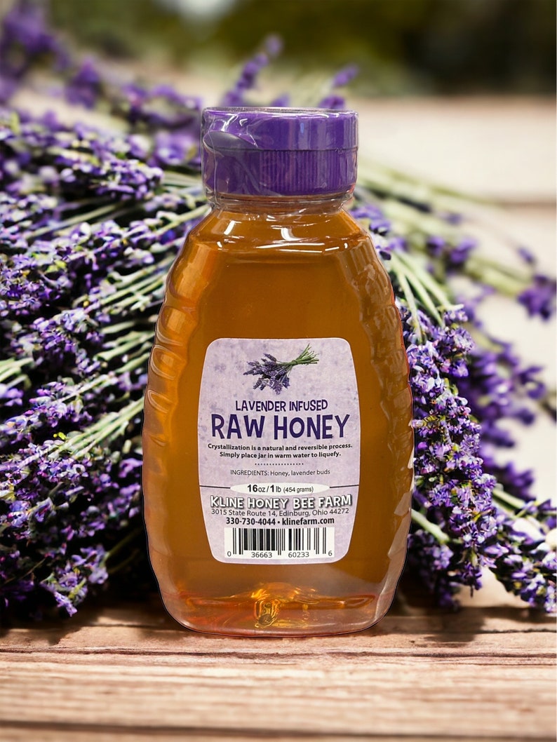 May include: A glass bottle of lavender infused raw honey with a purple lid. The label reads "Lavender Infused Raw Honey" and includes the ingredients, weight, and contact information for Kline Honey Bee Farm.