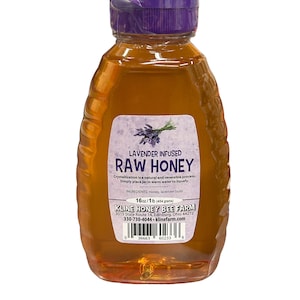 May include: A clear glass bottle of lavender infused raw honey with a purple lid. The label reads "Lavender Infused Raw Honey" and includes the ingredients: Honey, lavender buds. The label also includes the company name "Kline Honey Bee Farm" and contact information.