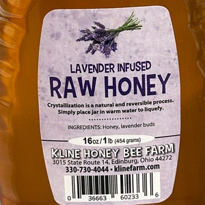 May include: A clear glass bottle of lavender infused raw honey with a white label. The label has a purple and green lavender flower graphic, the text "Lavender Infused Raw Honey", and the ingredients "Honey, lavender buds". The label also includes the brand name "Kline Honey Bee Farm", the address "3015 State Route 14, Edinburg, Ohio 44272", the phone number "330-730-4044", the website "klinefarm.com", and a barcode.
