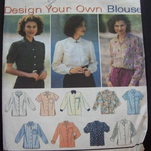 May include: A Simplicity sewing pattern titled "Design Your Own Blouse." The pattern features images of blouses in various styles and fabrics, including polka dots, floral prints, and stripes. The pattern size is K 8, 10, 12.