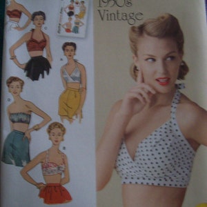 May include: Vintage 1950s sewing pattern for a halter top with polka dots. The pattern includes instructions for making a variety of styles, including a skirt and shorts. The pattern is from Simplicity and has the number 1426 D5 on it.
