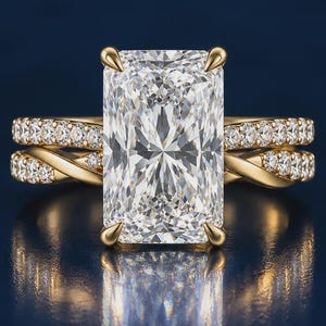 May include: A gold ring featuring a large rectangular radiant-cut center diamond held by four prongs. The band displays a twisted design encrusted with small round diamonds. The text Zyvera Diamonds is printed below the ring.