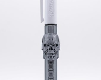 May include: A multi-color Bic ballpoint pen featuring a white top section with a pocket clip and a custom 3D-printed silver-colored barrel. The barrel displays a detailed robotic skull design and the embossed text T-800 along the lower portion.